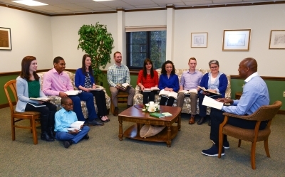 People at a home fellowship with Bibles open