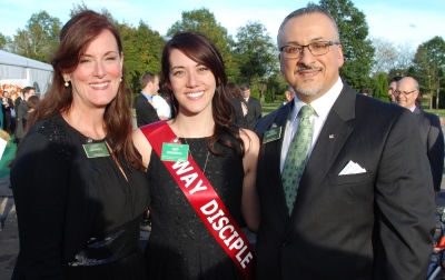 A Way Disciple with her sash, posing with her parents