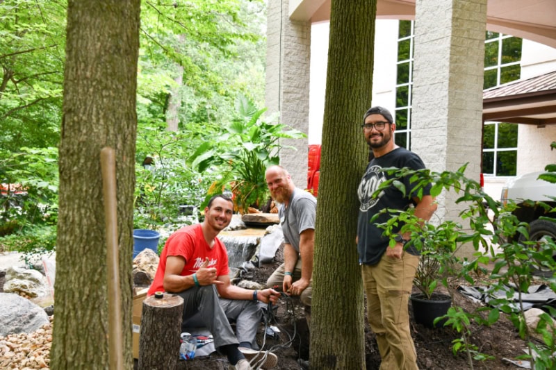 Grounds Crew Installing Fountain outside Auditorium